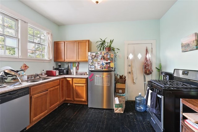 kitchen featuring sink, appliances with stainless steel finishes, and dark hardwood / wood-style flooring