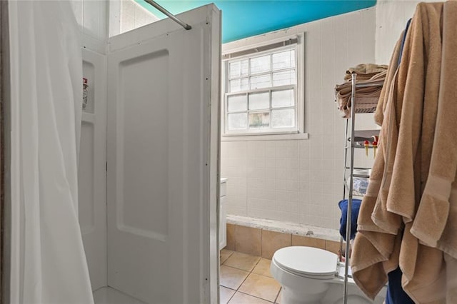 bathroom with toilet and tile patterned floors