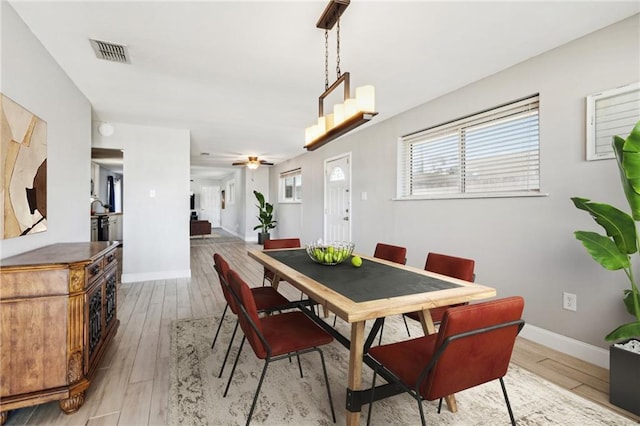 dining room with ceiling fan and light hardwood / wood-style floors