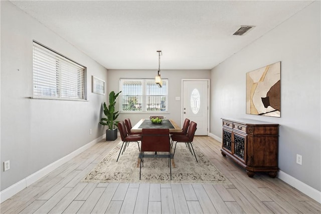 dining space with light wood-type flooring