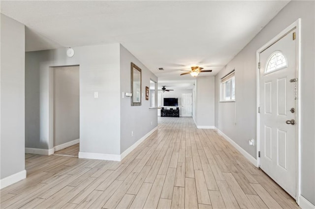 foyer entrance with light hardwood / wood-style flooring and ceiling fan