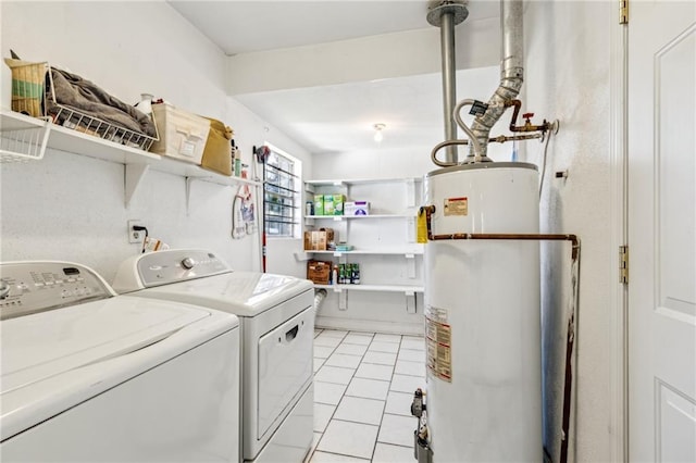 laundry area with washer and clothes dryer, water heater, and light tile patterned flooring