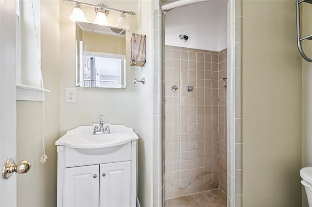 bathroom featuring vanity, toilet, and walk in shower