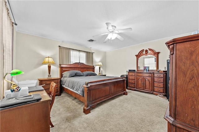 bedroom with crown molding, light colored carpet, and ceiling fan