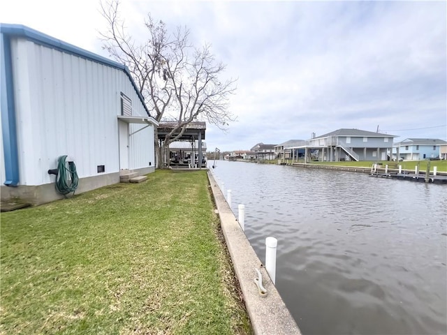 view of water feature with a dock and a residential view