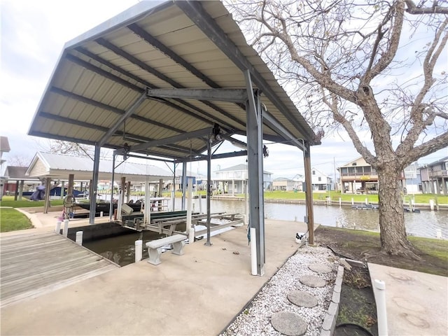 view of dock featuring a water view, boat lift, and a residential view