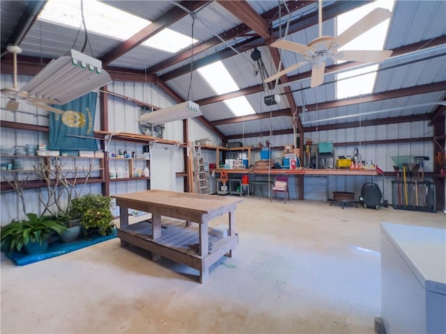 garage with ceiling fan, a workshop area, metal wall, and a garage door opener