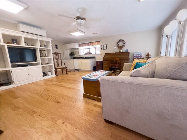 living room featuring light hardwood / wood-style flooring, ceiling fan, french doors, and a wealth of natural light