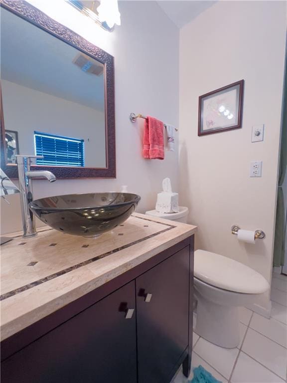 bathroom featuring visible vents, vanity, toilet, and tile patterned floors