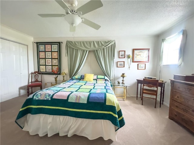 carpeted bedroom featuring a textured ceiling, ceiling fan, a closet, and baseboards