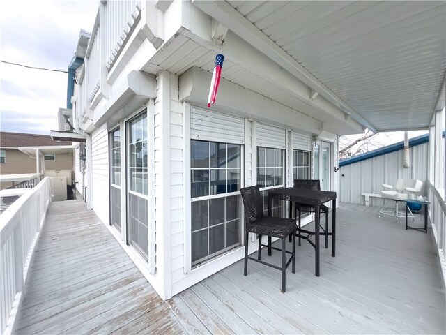 view of dock with a water view and a yard