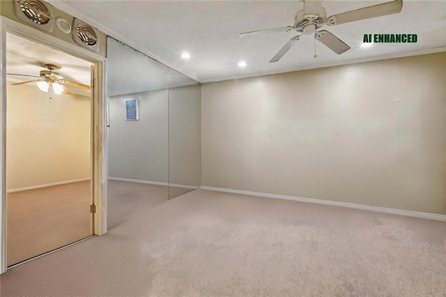 carpeted spare room with ceiling fan