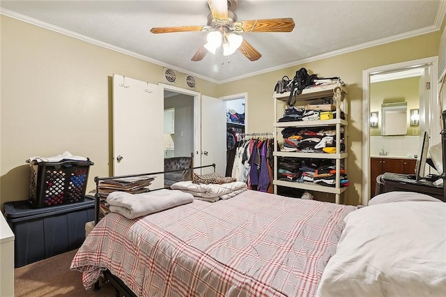 carpeted bedroom with crown molding, a closet, and ceiling fan