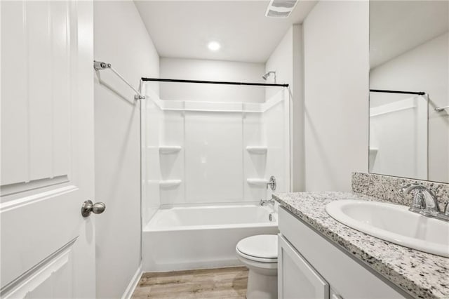 full bathroom featuring vanity, toilet, hardwood / wood-style floors, and  shower combination