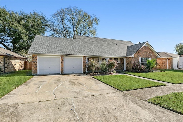 ranch-style home with an attached garage, brick siding, a shingled roof, concrete driveway, and a front lawn