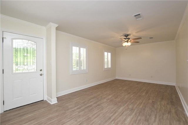 entryway with hardwood / wood-style floors, ornamental molding, and ceiling fan