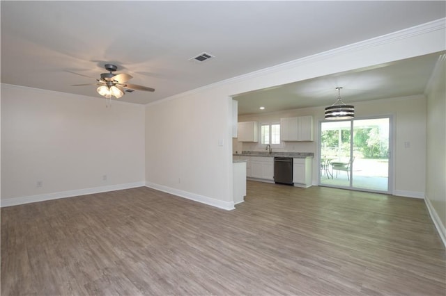 unfurnished living room with ornamental molding, hardwood / wood-style floors, and ceiling fan