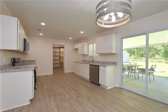 kitchen with appliances with stainless steel finishes, sink, light hardwood / wood-style flooring, and white cabinets