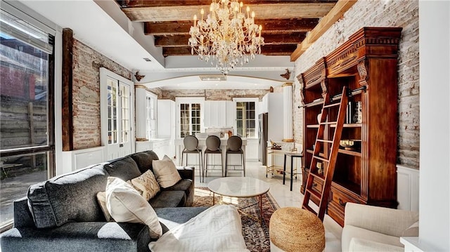 interior space with beam ceiling and a chandelier