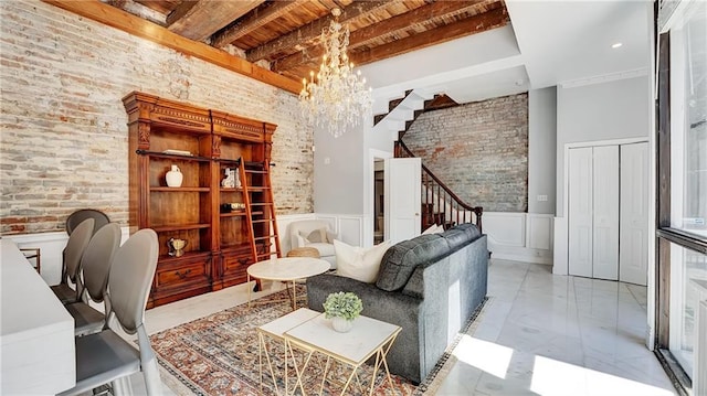 office space with a notable chandelier, beam ceiling, and brick wall