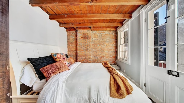 bedroom featuring beam ceiling, brick wall, and wood ceiling