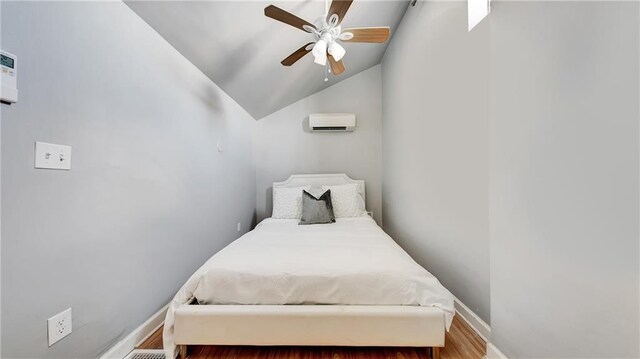 bedroom with vaulted ceiling, a wall mounted AC, and ceiling fan