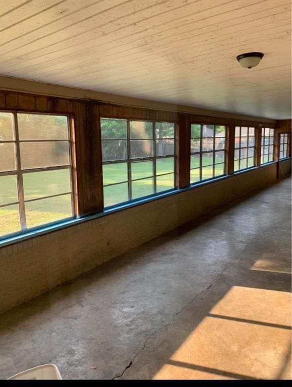 unfurnished sunroom with a wealth of natural light