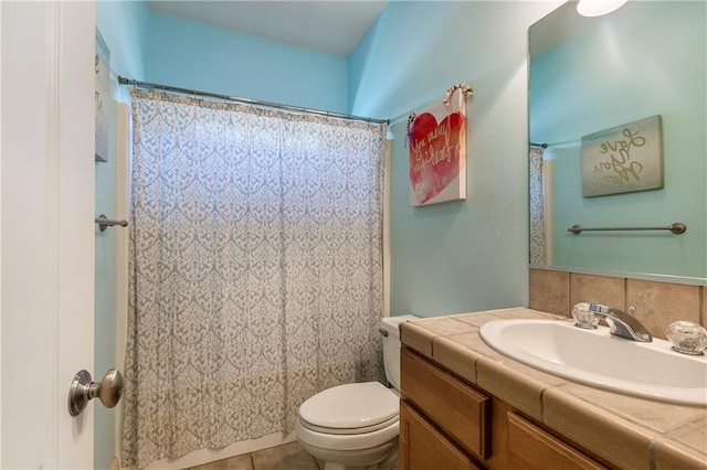 bathroom with vanity, decorative backsplash, tile patterned floors, and toilet