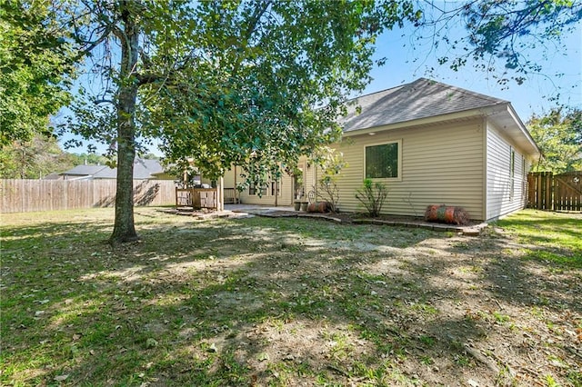 rear view of house with a yard