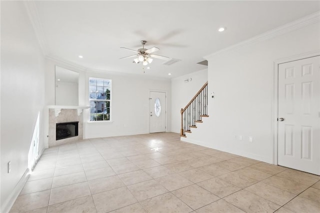 unfurnished living room with crown molding, a high end fireplace, light tile patterned floors, and ceiling fan