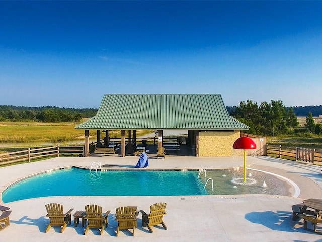 pool with a patio, a gazebo, and fence