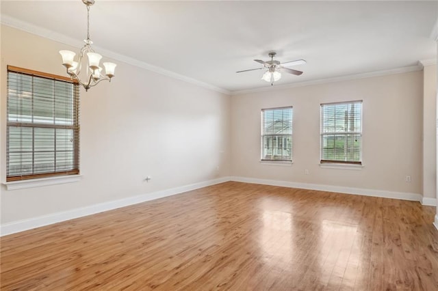 unfurnished room with ornamental molding, ceiling fan with notable chandelier, and light hardwood / wood-style flooring