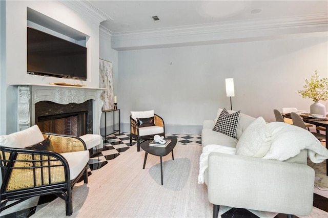 living room with crown molding and a high end fireplace