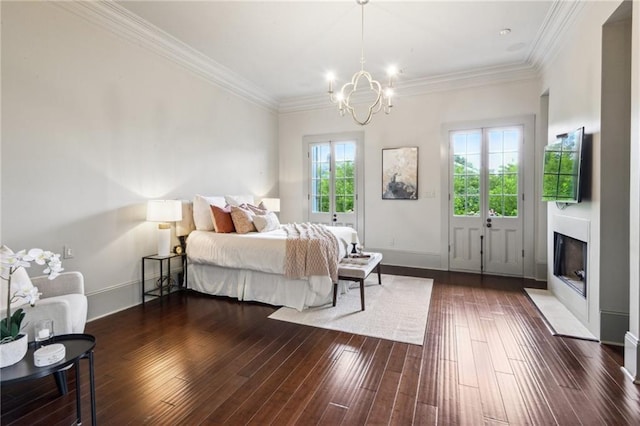 bedroom featuring multiple windows, a notable chandelier, dark wood-type flooring, and ornamental molding