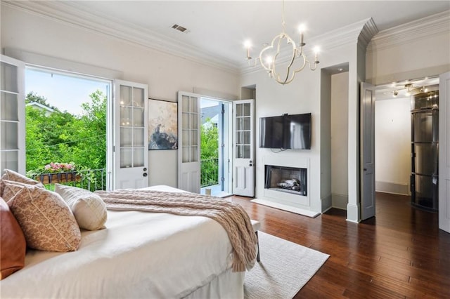 bedroom featuring crown molding, a chandelier, dark wood-type flooring, and access to outside