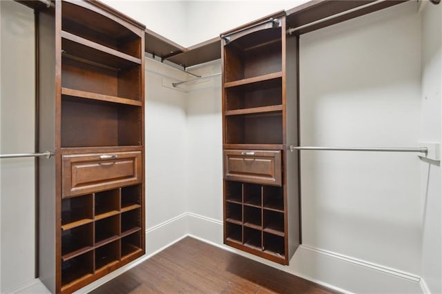 walk in closet featuring dark wood-type flooring