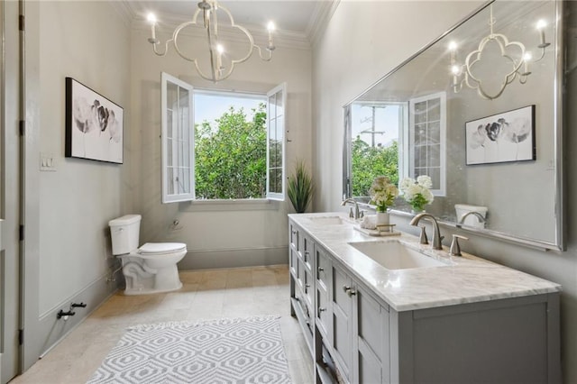 bathroom featuring vanity, a notable chandelier, crown molding, and toilet