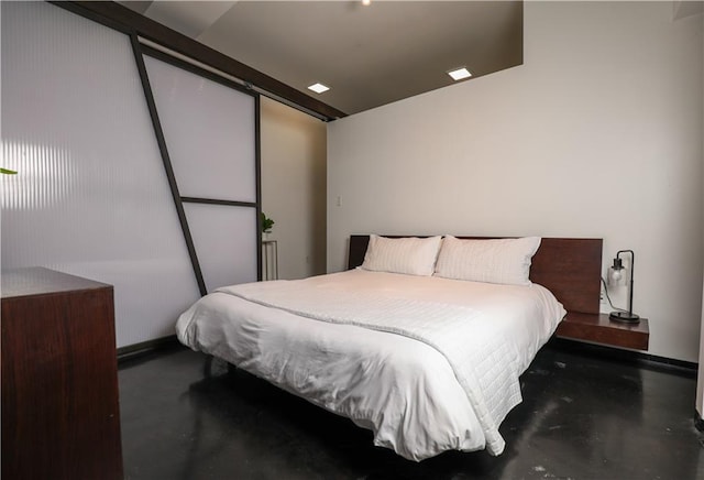 bedroom featuring concrete floors