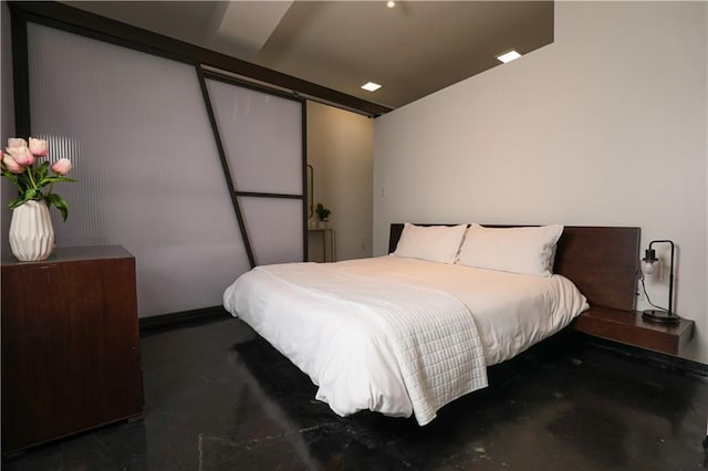 bedroom featuring concrete floors