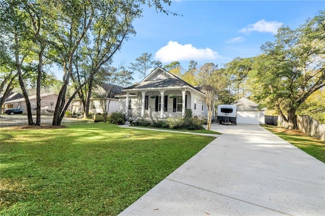 view of front of house featuring an outbuilding, a garage, covered porch, and a front yard