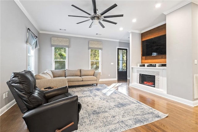 living room with crown molding, ceiling fan, and hardwood / wood-style flooring