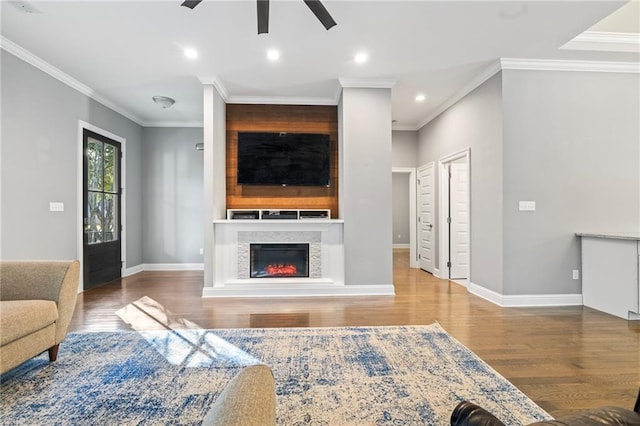 living room featuring crown molding, ceiling fan, and wood-type flooring