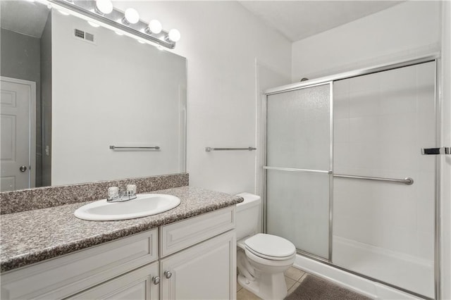 bathroom featuring vanity, an enclosed shower, tile patterned floors, and toilet