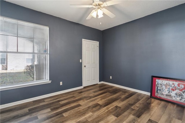 spare room featuring dark hardwood / wood-style floors and ceiling fan