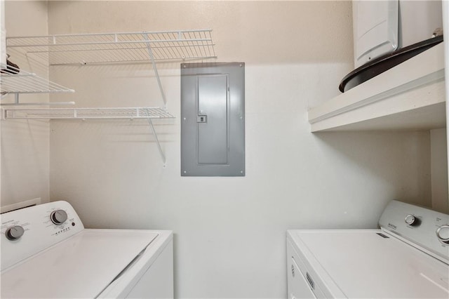 clothes washing area with washer and dryer and electric panel