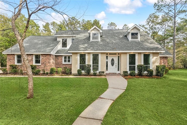 cape cod-style house with a front yard