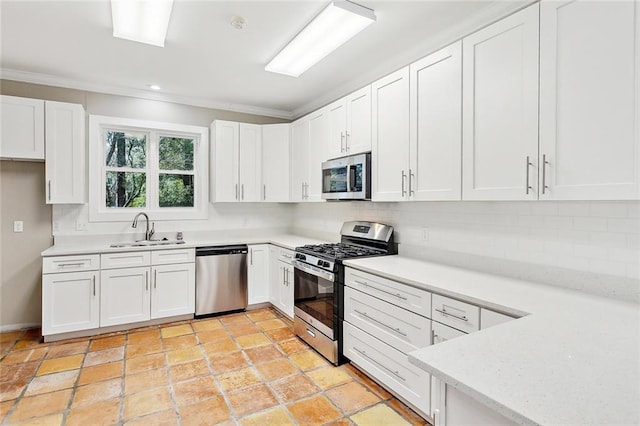 kitchen featuring backsplash, appliances with stainless steel finishes, sink, and white cabinets