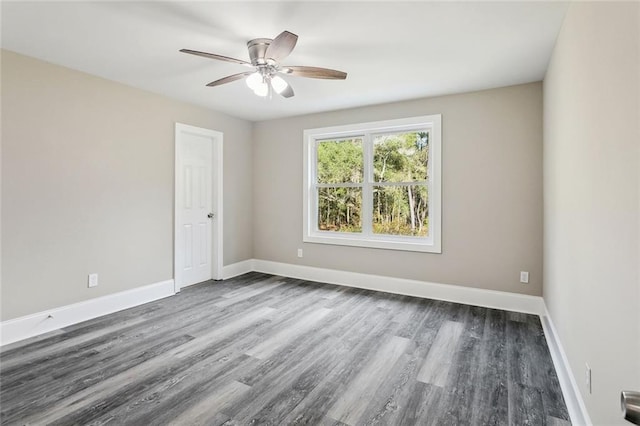 spare room with ceiling fan and dark hardwood / wood-style flooring