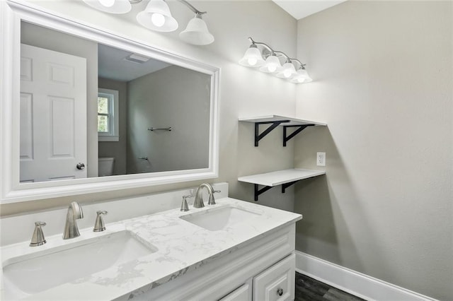 bathroom featuring vanity, toilet, and wood-type flooring