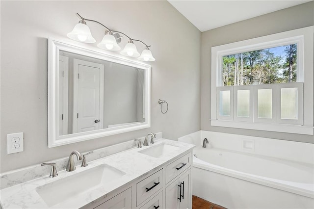 bathroom featuring vanity and a bath